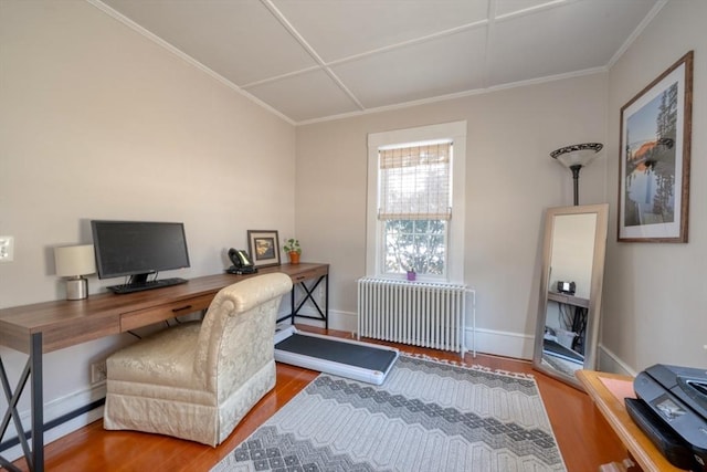 office area featuring radiator heating unit, baseboards, wood finished floors, and ornamental molding