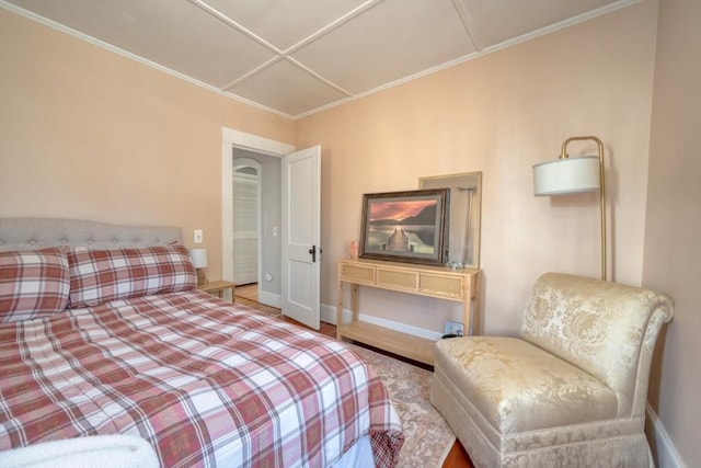 bedroom with crown molding and baseboards