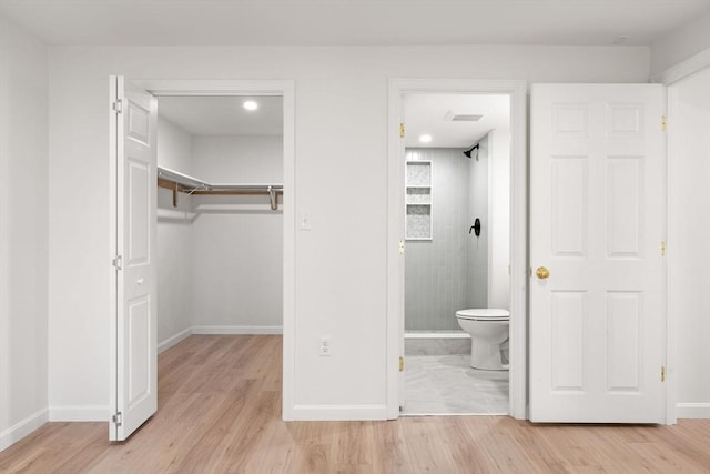 64 Willard St Unit 408, Quincy, MA 02169 - unfurnished bedroom with light wood-style flooring, a spacious closet, and a closet