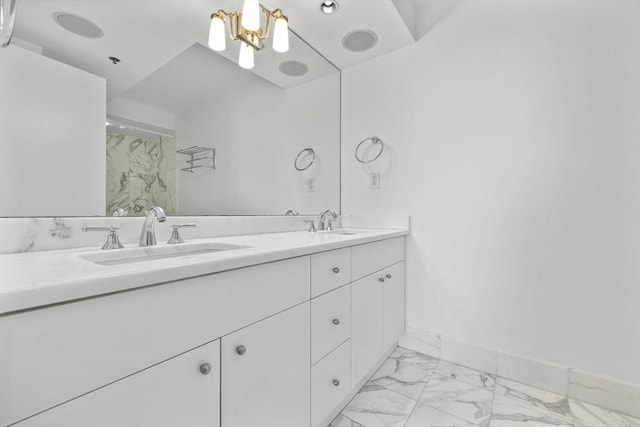 full bathroom with marble finish floors, baseboards, double vanity, a shower, and a chandelier
