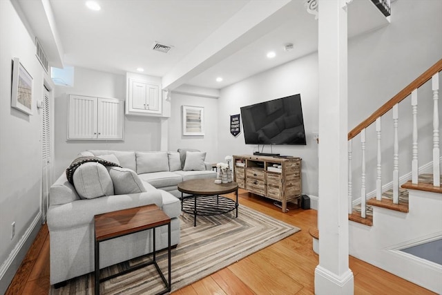 living room with recessed lighting, wood finished floors, and visible vents