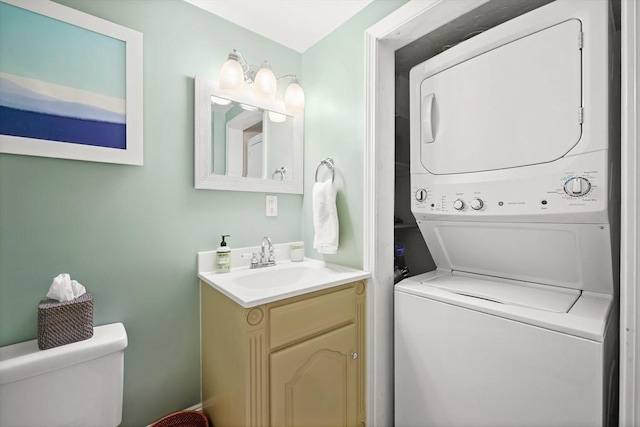 clothes washing area with laundry area, a sink, and stacked washer / drying machine