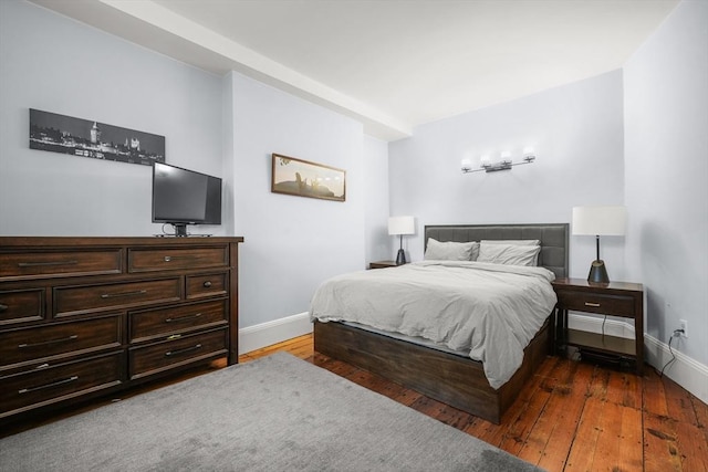 bedroom featuring baseboards and hardwood / wood-style floors