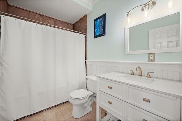 full bath with tile patterned floors, a wainscoted wall, vanity, toilet, and shower / bathtub combination with curtain