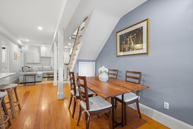 dining area with recessed lighting, baseboards, stairway, and light wood-type flooring