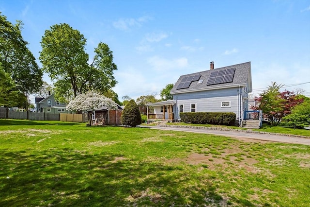 28 Sterling St, Weymouth, MA 02188 - rear view of house featuring solar panels, a chimney, and roof with shingles