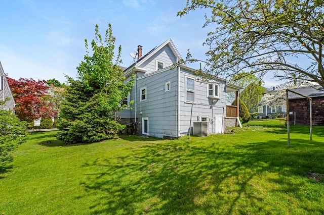 28 Sterling St, Weymouth, MA 02188 - back of property with a chimney, a lawn, and central AC