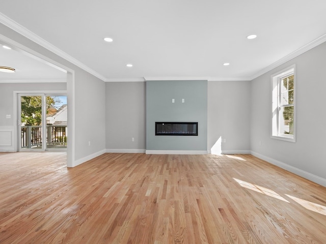 unfurnished living room featuring ornamental molding and light wood-type flooring