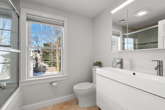 full bathroom with toilet, vanity, combined bath / shower with glass door, and a healthy amount of sunlight