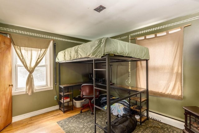 192 Sherbert Rd, Ashburnham, MA 01430 - bedroom with a baseboard heating unit, baseboards, and wood finished floors