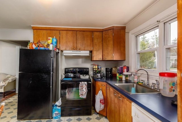 192 Sherbert Rd, Ashburnham, MA 01430 - kitchen with brown cabinets, under cabinet range hood, dark countertops, a sink, and black appliances