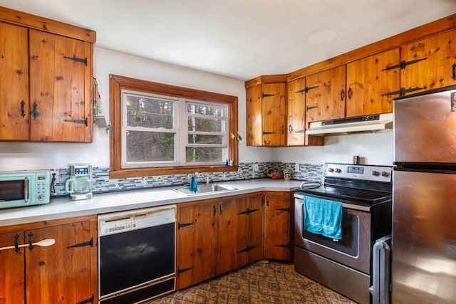 192 Sherbert Rd, Ashburnham, MA 01430 - kitchen with stainless steel appliances, a sink, brown cabinetry, light countertops, and under cabinet range hood