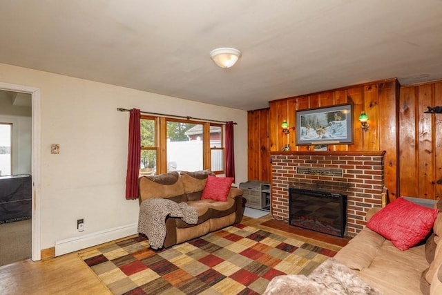 192 Sherbert Rd, Ashburnham, MA 01430 - living room featuring wood finished floors, a brick fireplace, wood walls, and baseboards