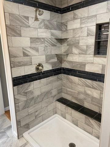 bathroom with a tile shower