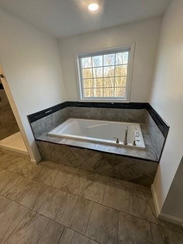 bathroom with tiled tub