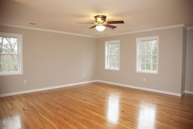 unfurnished room featuring crown molding, a healthy amount of sunlight, and light hardwood / wood-style floors