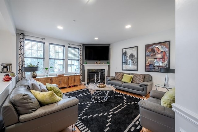 living area featuring recessed lighting and a tile fireplace