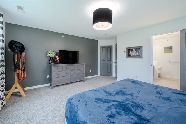 bedroom with baseboards, carpet, ensuite bath, and visible vents