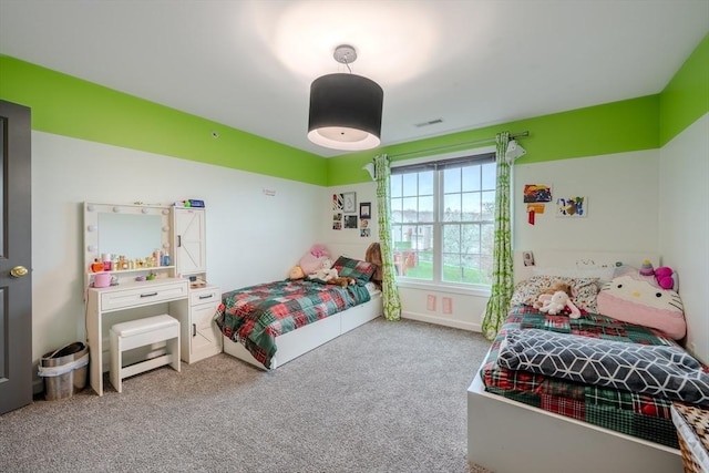 carpeted bedroom featuring visible vents