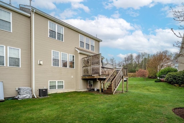 back of property with a yard, a wooden deck, stairs, and central air condition unit