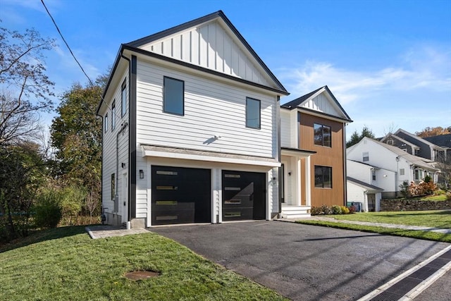 view of front of property featuring a garage and a front lawn