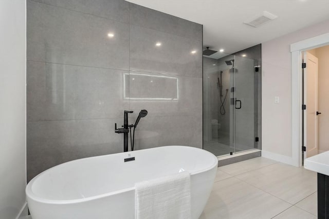 bathroom featuring tile patterned flooring, vanity, and separate shower and tub