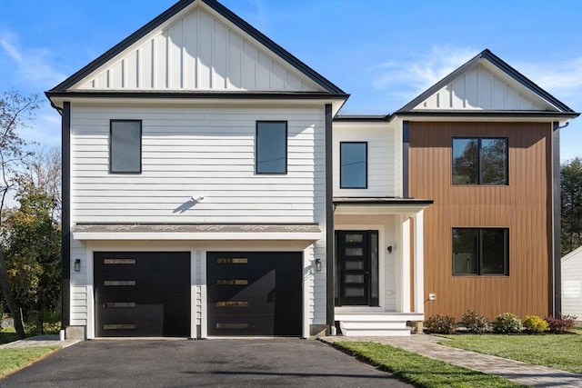 modern inspired farmhouse with a garage