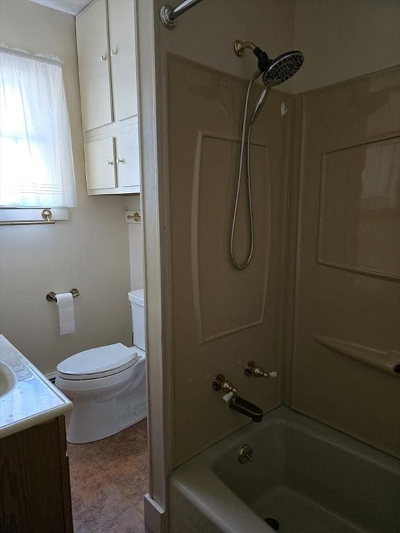 bathroom with toilet, vanity, and shower / tub combination