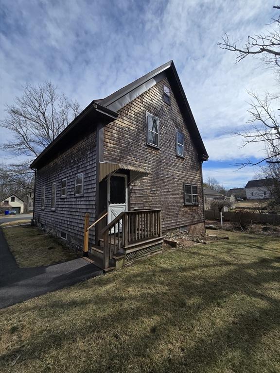 rear view of property with a yard