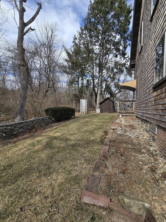 view of yard with an outbuilding and a shed