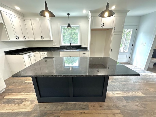 90 Bald Mountain Rd, Bernardston, MA 01337 - kitchen featuring white cabinets, wood finished floors, a center island, a sink, and baseboards