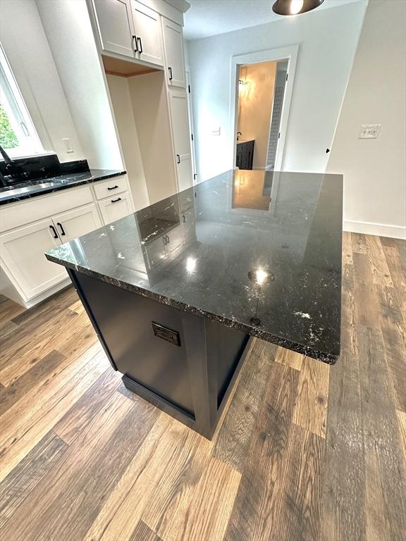 90 Bald Mountain Rd, Bernardston, MA 01337 - kitchen featuring wood finished floors, a large island, dark stone countertops, and white cabinetry
