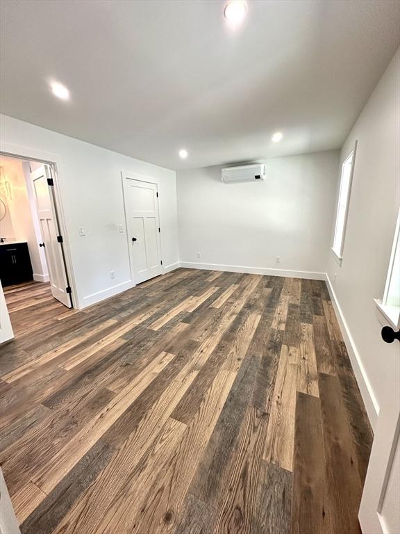 90 Bald Mountain Rd, Bernardston, MA 01337 - unfurnished room featuring a wall unit AC, wood finished floors, recessed lighting, and baseboards