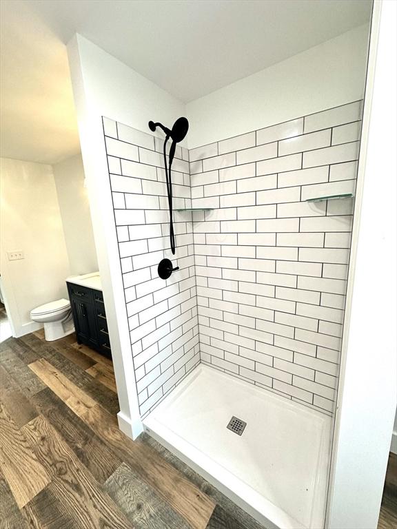 90 Bald Mountain Rd, Bernardston, MA 01337 - bathroom with a stall shower, wood finished floors, vanity, and toilet