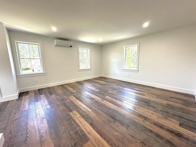 90 Bald Mountain Rd, Bernardston, MA 01337 - unfurnished room with an AC wall unit, plenty of natural light, dark wood-style floors, baseboards, and recessed lighting