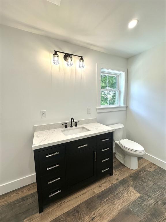 90 Bald Mountain Rd, Bernardston, MA 01337 - bathroom featuring vanity, toilet, wood finished floors, and baseboards