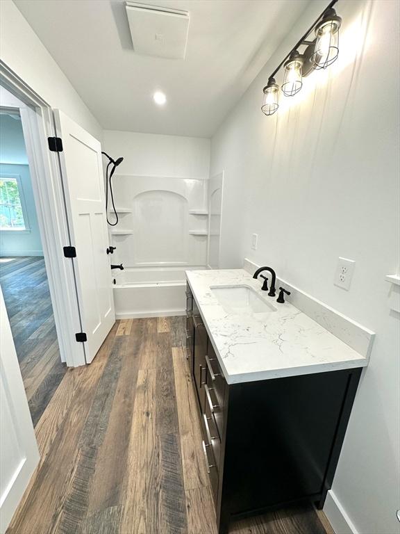 90 Bald Mountain Rd, Bernardston, MA 01337 - full bathroom with vanity, wood finished floors, and  shower combination