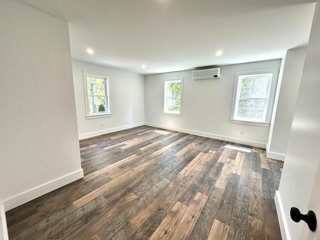 90 Bald Mountain Rd, Bernardston, MA 01337 - empty room with a wall unit AC, dark wood finished floors, baseboards, and recessed lighting