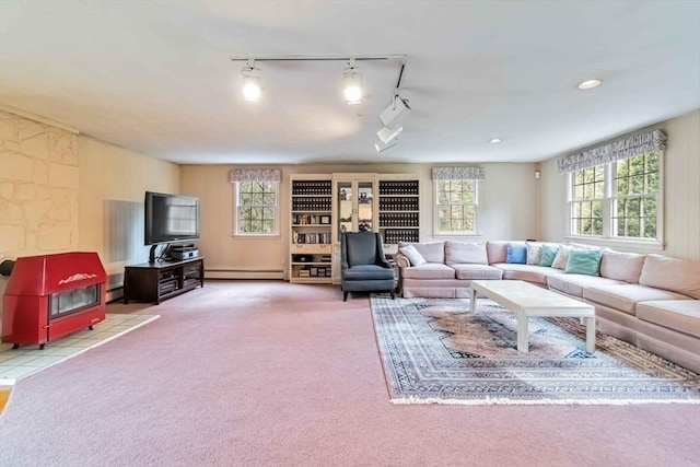 10 Mallard Rd, Acton, MA 01720 - carpeted living room featuring a wood stove, baseboard heating, a baseboard radiator, and rail lighting
