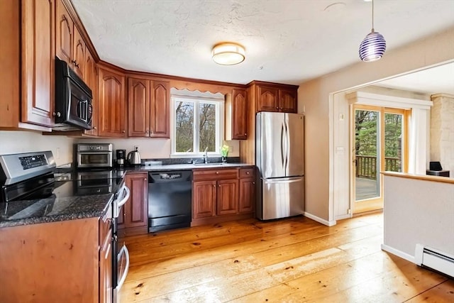10 Mallard Rd, Acton, MA 01720 - kitchen with a healthy amount of sunlight, a baseboard heating unit, black appliances, and a sink