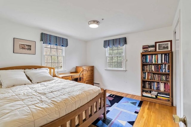 10 Mallard Rd, Acton, MA 01720 - bedroom featuring baseboards, multiple windows, baseboard heating, and hardwood / wood-style flooring