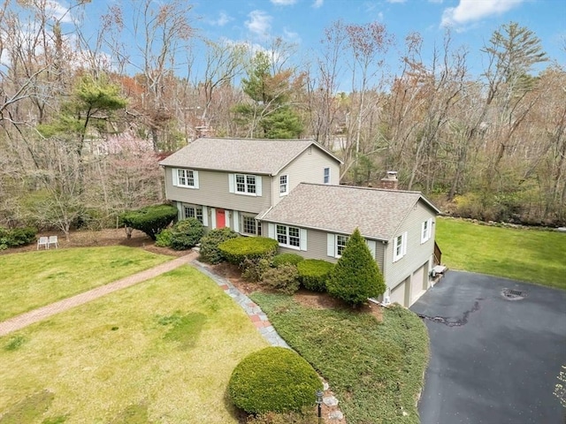 10 Mallard Rd, Acton, MA 01720 - traditional home with an attached garage, a chimney, driveway, a front yard, and roof with shingles