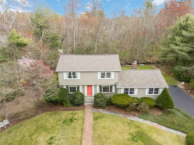 10 Mallard Rd, Acton, MA 01720 - view of front of property featuring a shingled roof, a forest view, a chimney, and a front yard