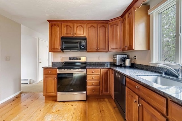 10 Mallard Rd, Acton, MA 01720 - kitchen with brown cabinetry, black appliances, a baseboard radiator, and a sink