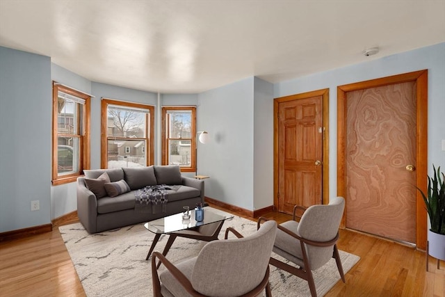 living room with light wood finished floors and baseboards