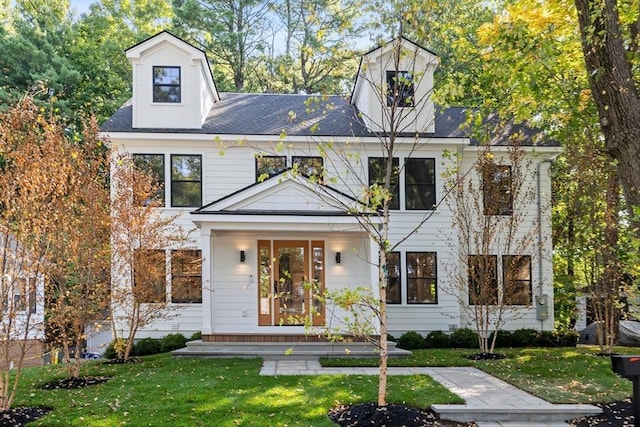 cape cod home with a front yard