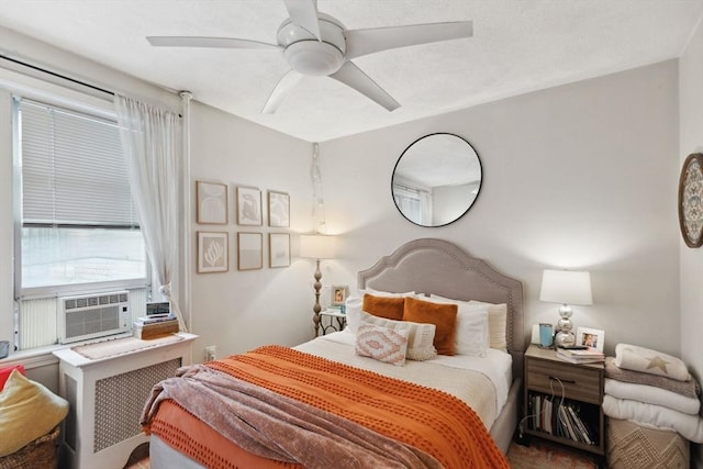 bedroom featuring cooling unit, radiator heating unit, and a ceiling fan