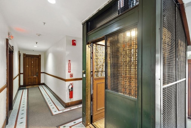 corridor featuring recessed lighting and baseboards