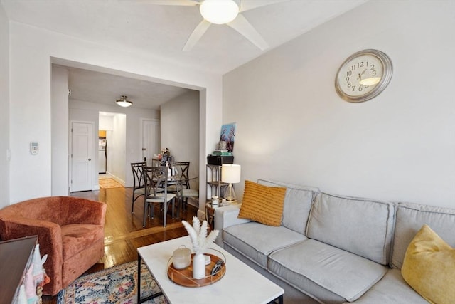 living room with ceiling fan and wood finished floors