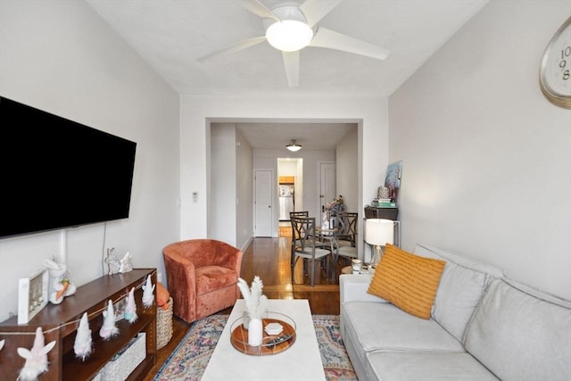 living room with wood finished floors and ceiling fan